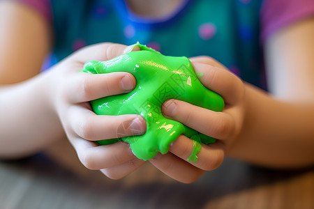 黏土玩具孩子手中拿着一块绿色粘土背景