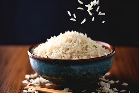 一碗米饭和筷子放在桌子上背景图片