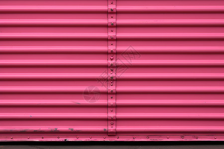 金属刷油漆喷刷的粉色卷帘门背景背景