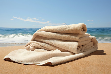 沙滩上堆放的一堆毛巾背景图片