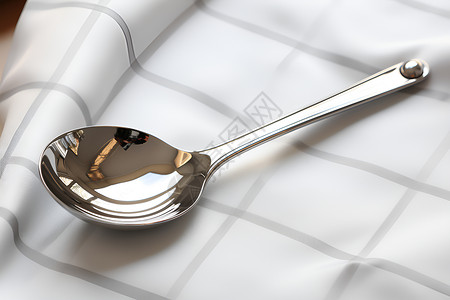 桌子上的不锈钢勺子背景图片
