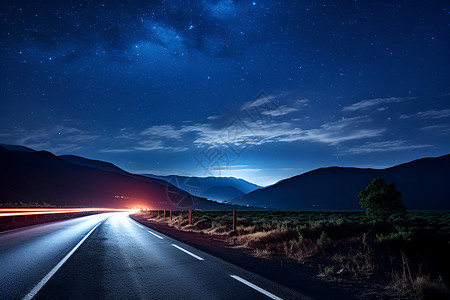 夜晚道路光照星空下的长路背景