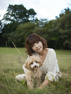 草地上的女人和狗背景图片